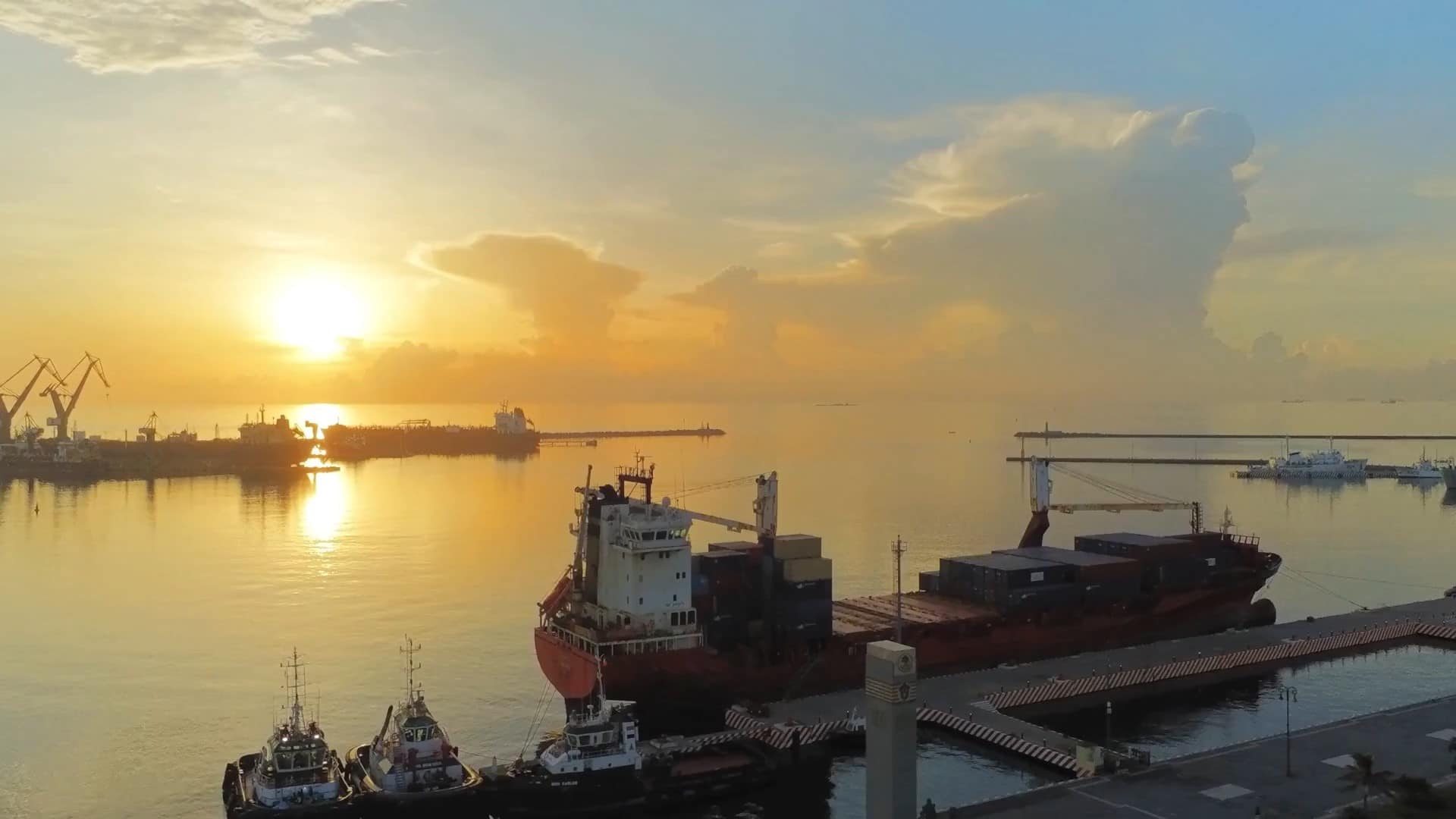 Ship at harbour with sunset in background