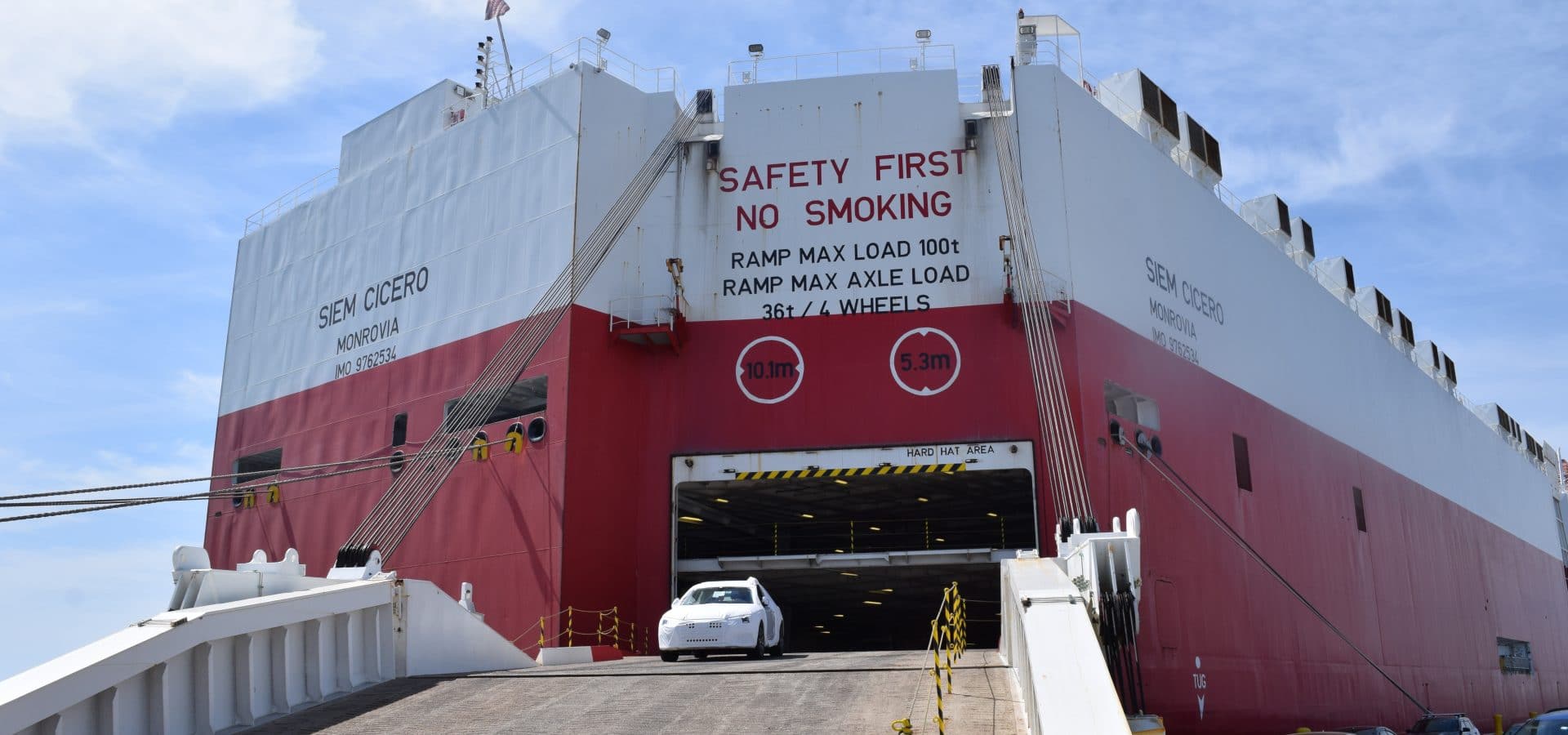 Car being unloaded from ship ramp
